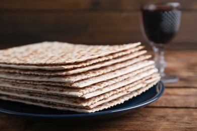 Photo of Stack of matzos on wooden table, closeup
