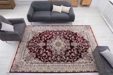 Photo of Cozy room interior with stylish furniture and soft carpet with beautiful pattern, view from above