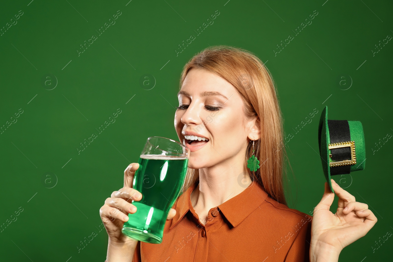 Photo of Young woman with green beer on color background. St. Patrick's Day celebration