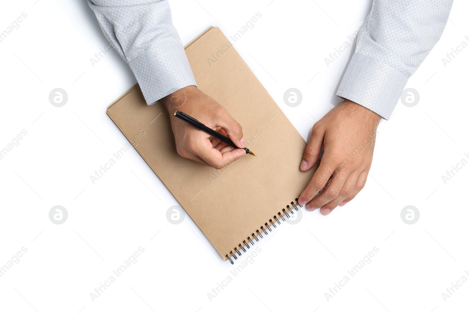 Photo of Man with pen and notepad on white background, top view. Closeup of hands