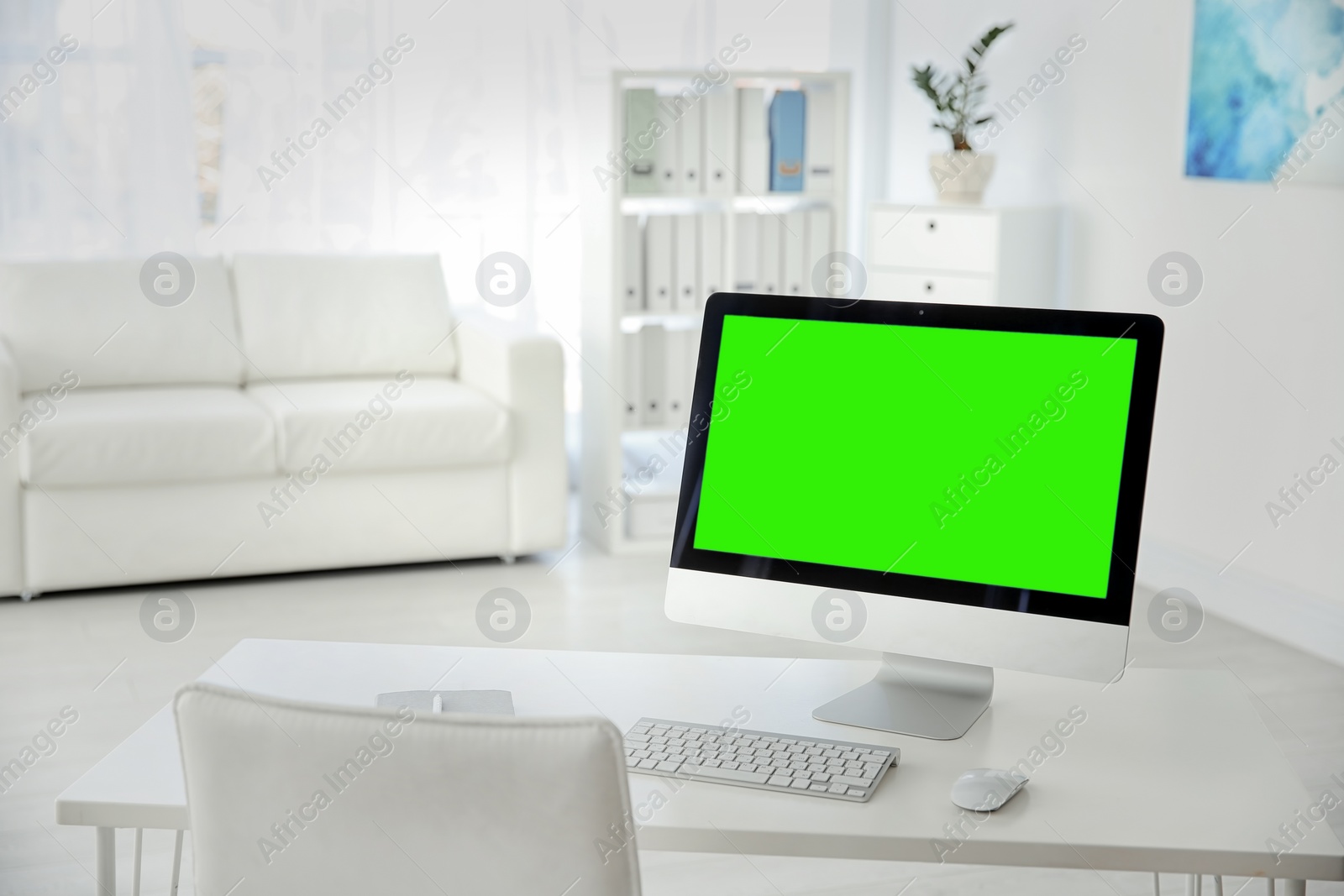 Image of Computer display with chroma key on desk indoors. Comfortable workplace