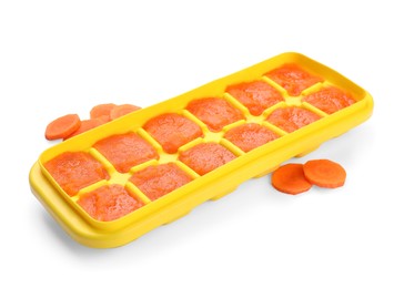 Photo of Carrot puree in ice cube tray isolated on white. Ready for freezing