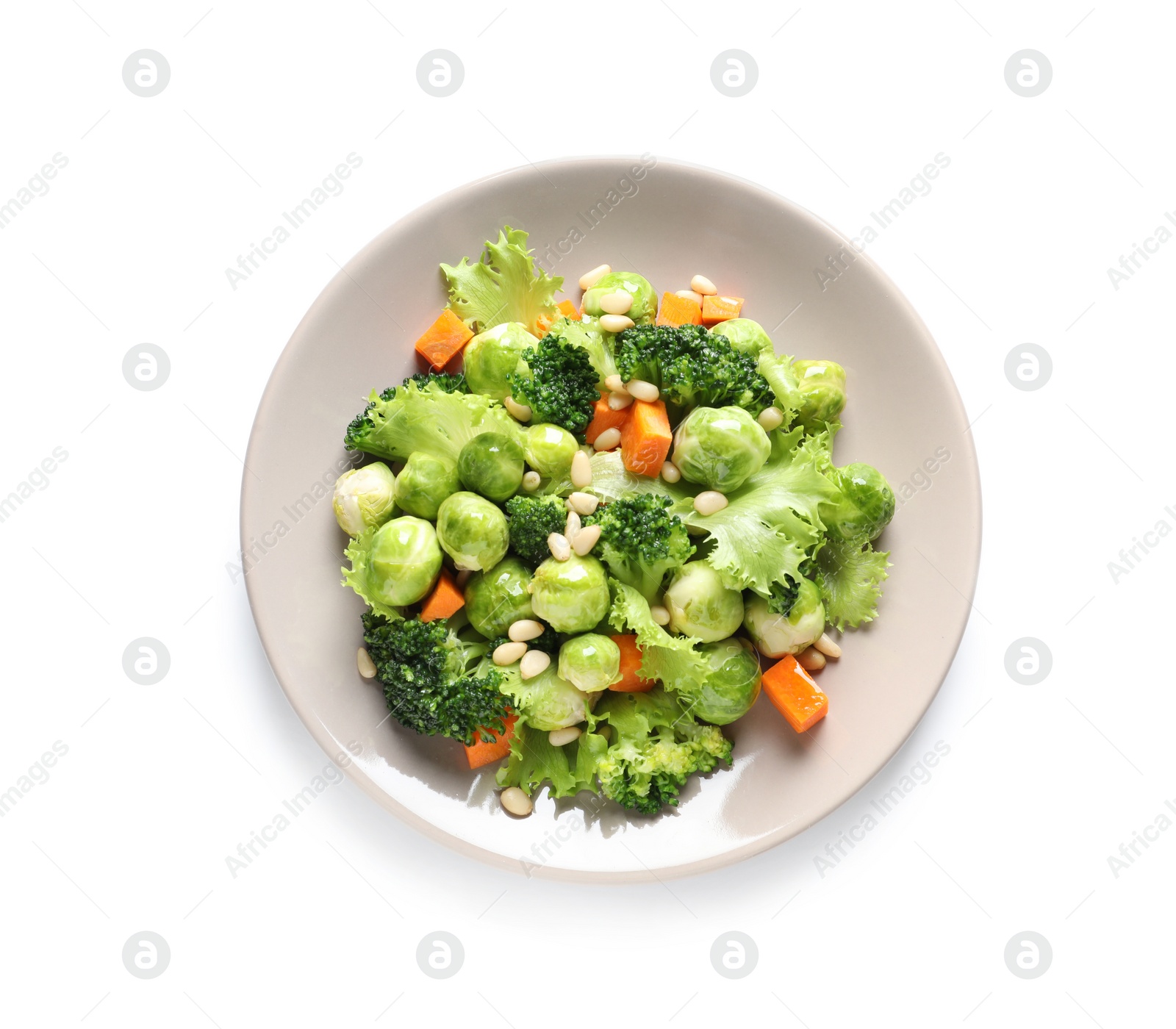 Photo of Plate of salad with Brussels sprouts isolated on white, top view