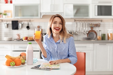 Photo of Portrait of food blogger with glass of juice in kitchen