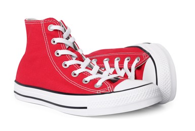 Photo of Pair of new red stylish high top plimsolls on white background