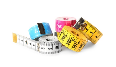Photo of Kit of different measuring tapes isolated on white