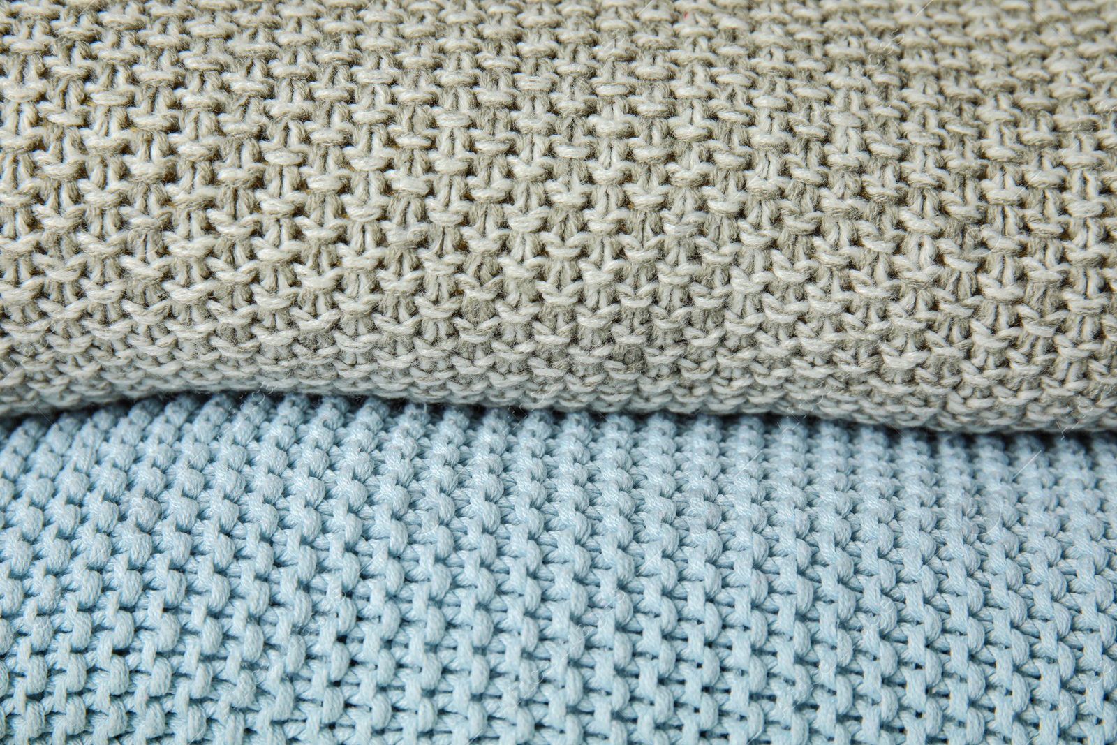Photo of Stack of soft warm plaids as background, closeup