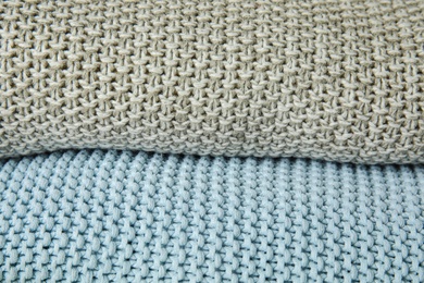 Stack of soft warm plaids as background, closeup