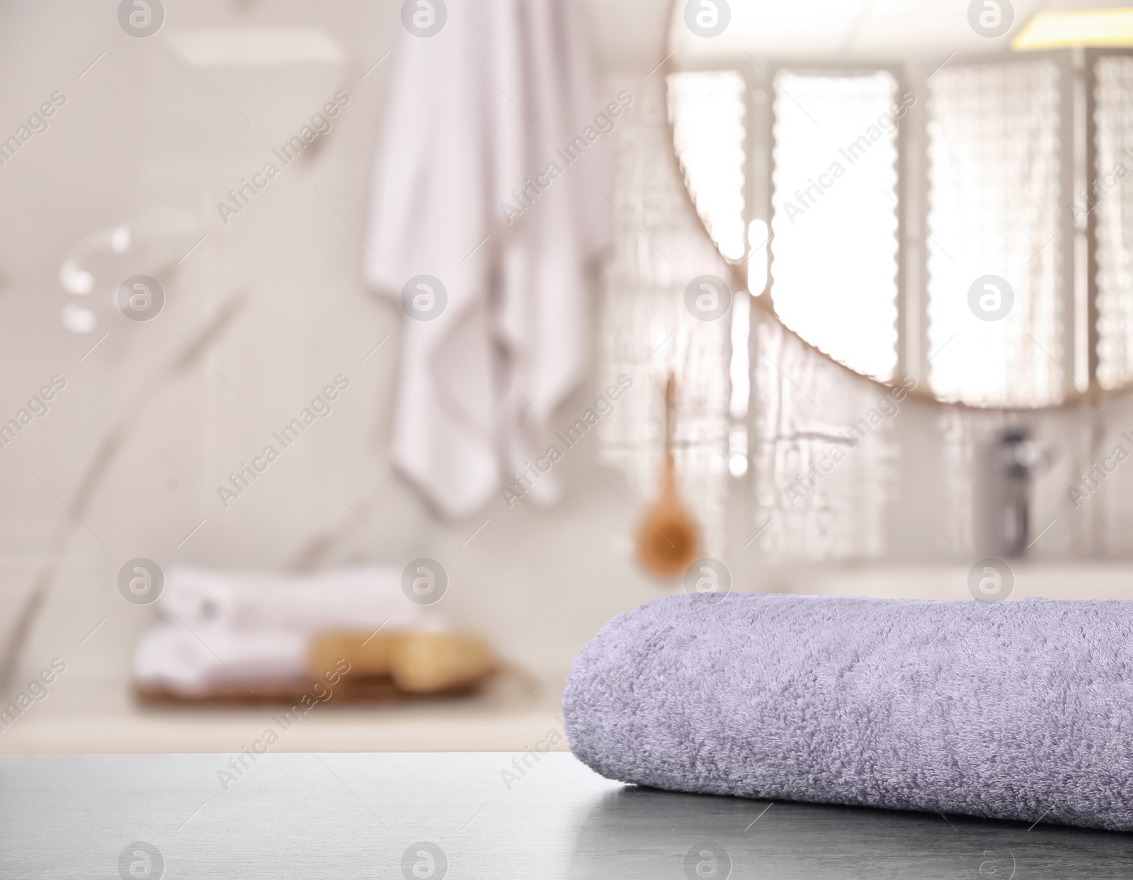 Image of Fresh towel on grey table in bathroom. Space for text