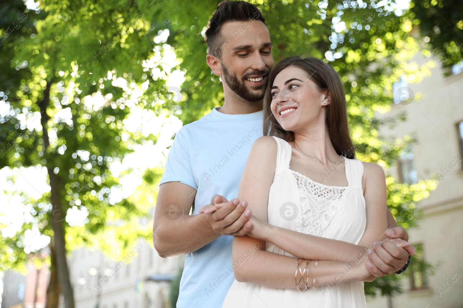 Photo of Lovely young couple dancing together in park on sunny day