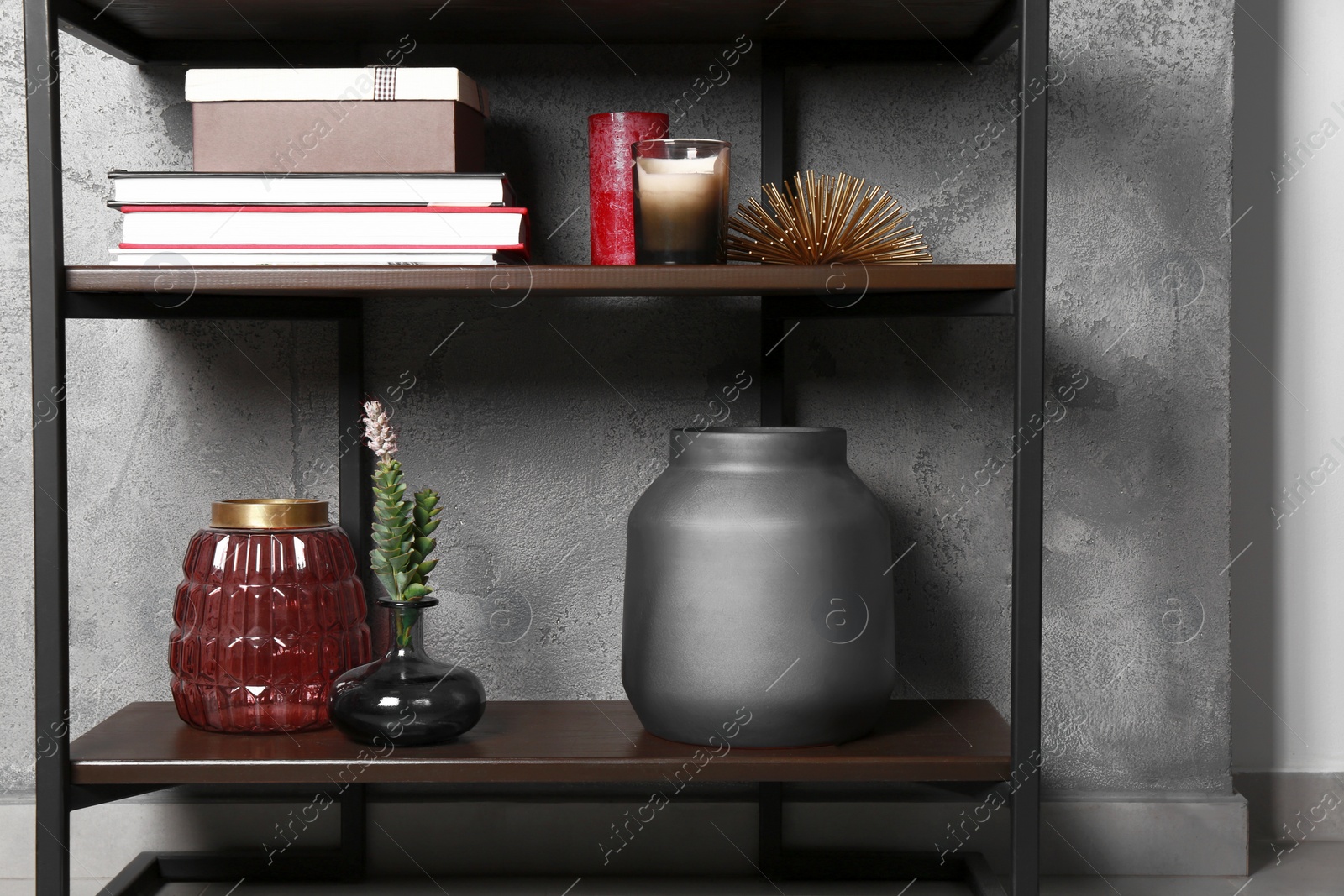 Photo of Stylish floor shelf with home decor. Interior design