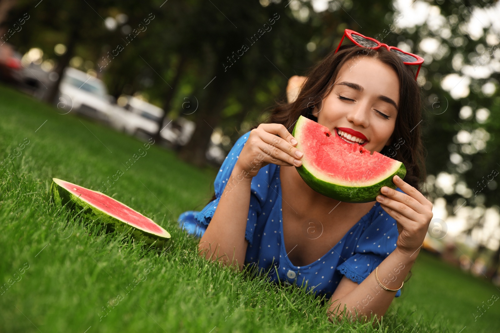 Photo of Beautiful young woman with watermelon in park on sunny day