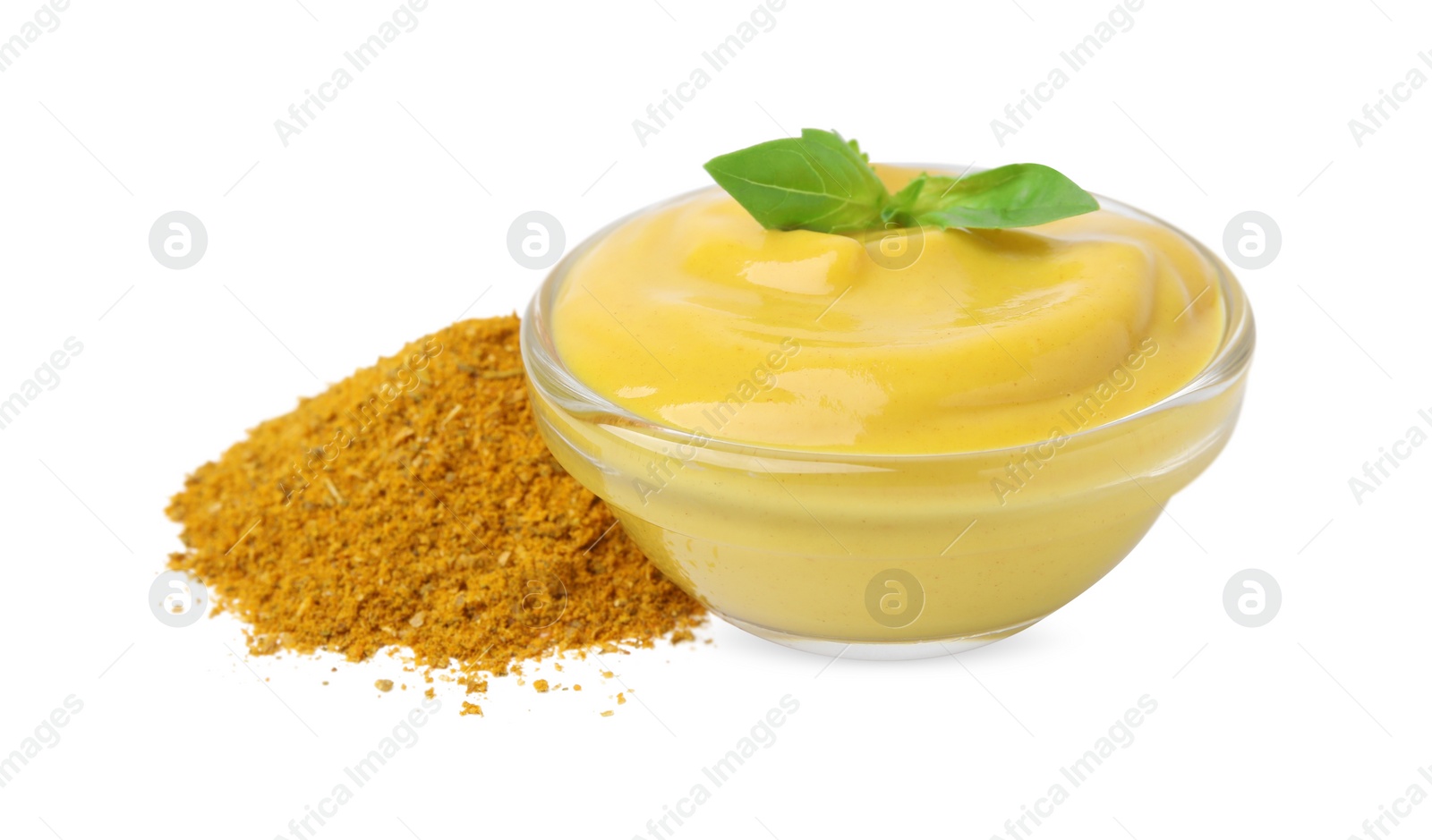 Photo of Bowl with tasty curry sauce, powder and basil isolated on white