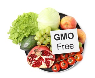 Photo of Fresh fruits, vegetables and card with text GMO Free on white background, top view