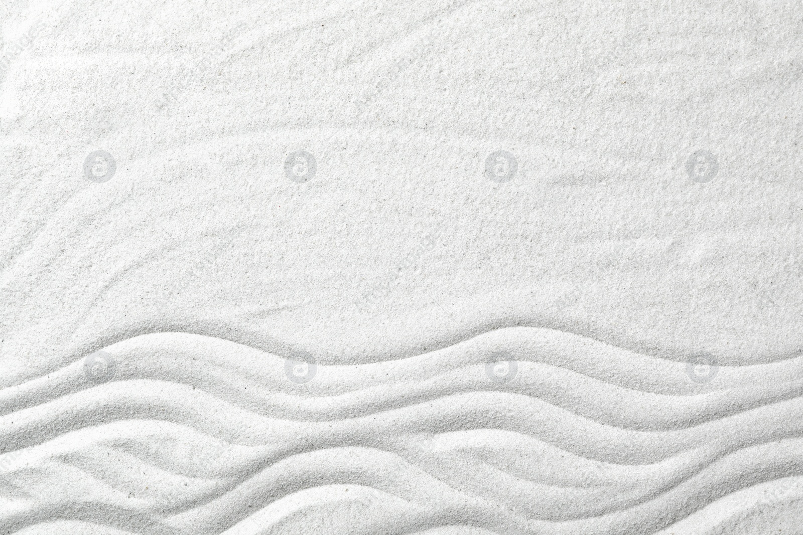Photo of Zen garden pattern on sand as background, top view with space for text. Meditation and harmony