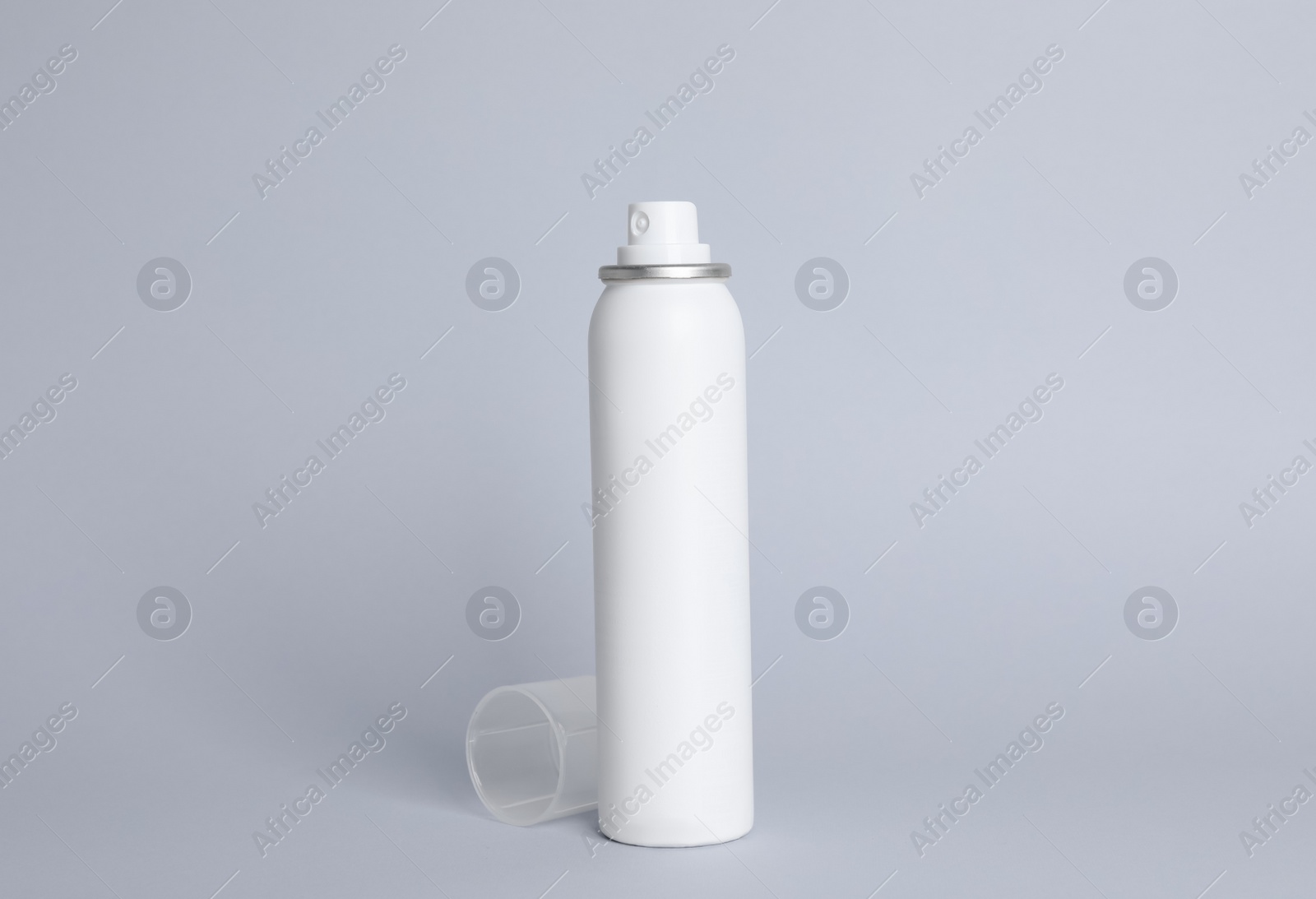 Photo of Bottle of dry shampoo on grey background