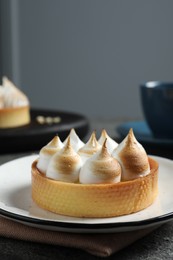 Tartlet with meringue served on table, closeup. Tasty dessert