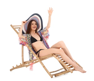 Young woman on sun lounger against white background. Beach accessories