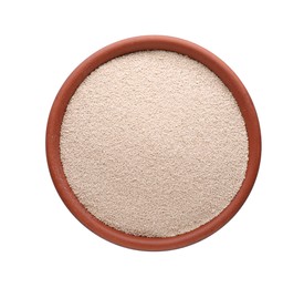 Photo of Bowl of active dry yeast isolated on white, top view