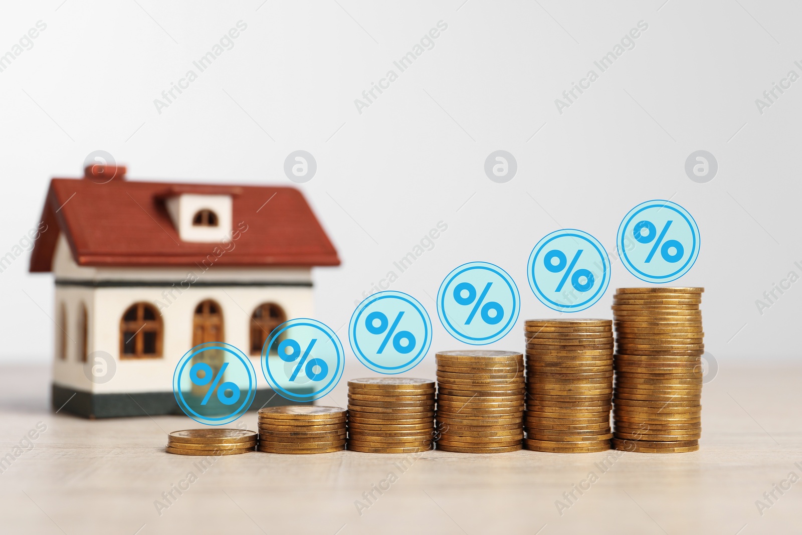 Image of Mortgage rate. Stacked coins, percent signs and model of house