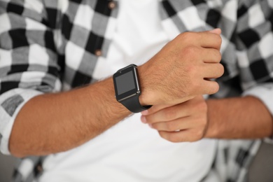 Photo of Man with modern smart watch device, closeup
