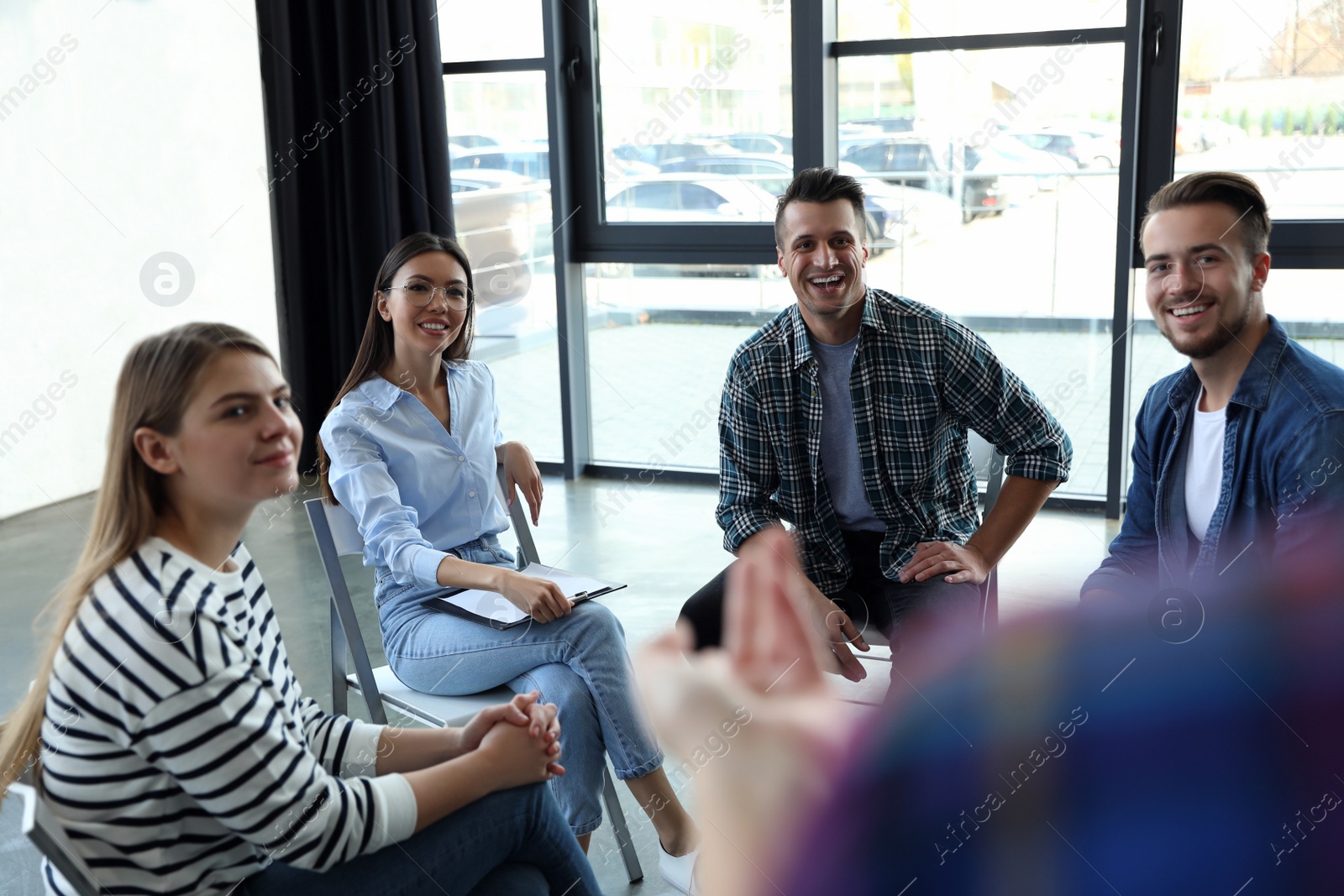 Photo of Psychotherapist working with patients in group therapy session indoors