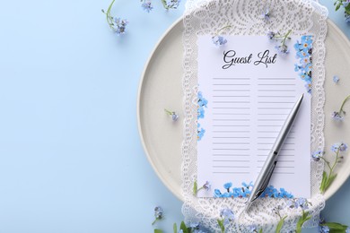 Photo of Plate with guest list, pen, lace and flowers on light blue background, flat lay. Space for text