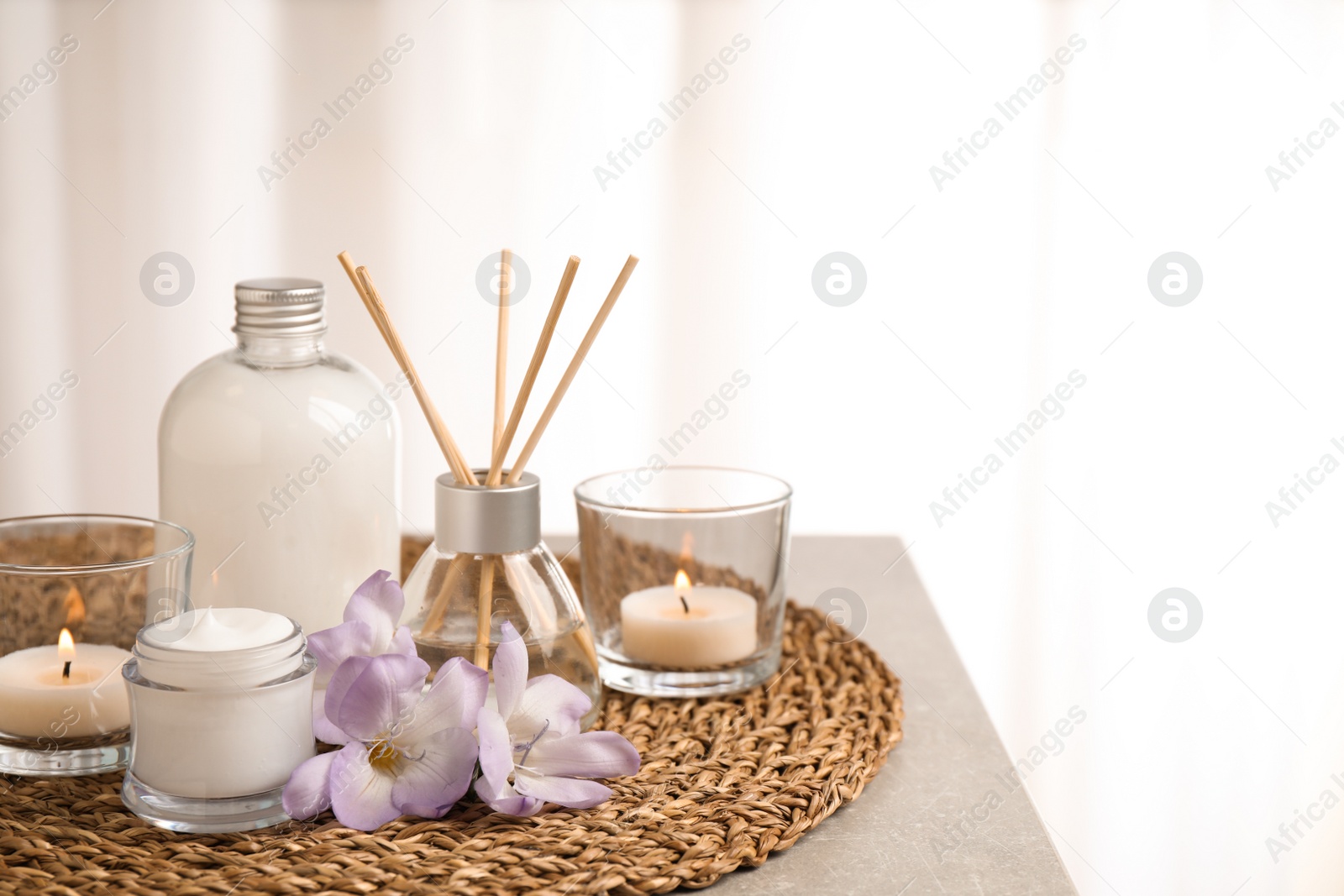 Photo of Composition with skin care products and reed air freshener on grey table, space for text