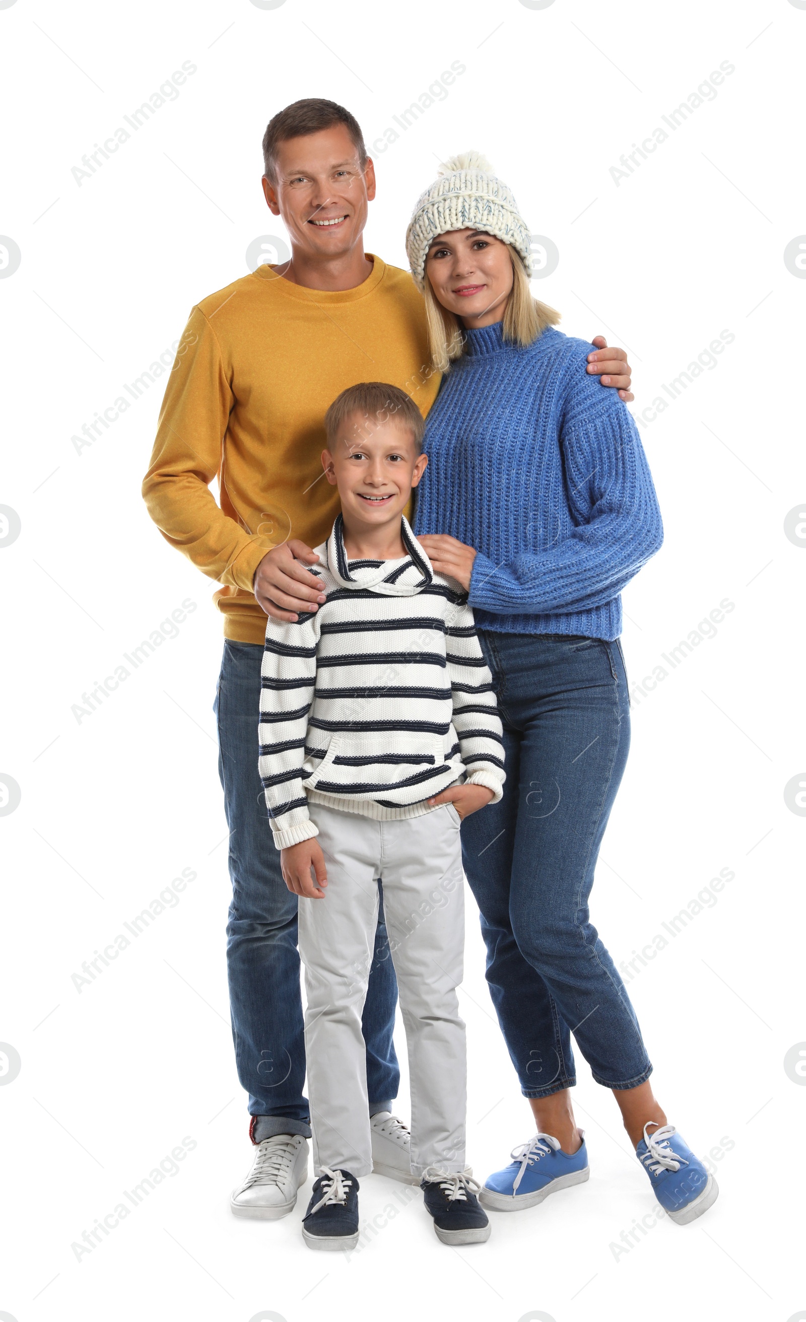 Photo of Happy family with child in warm sweaters on white background. Winter season