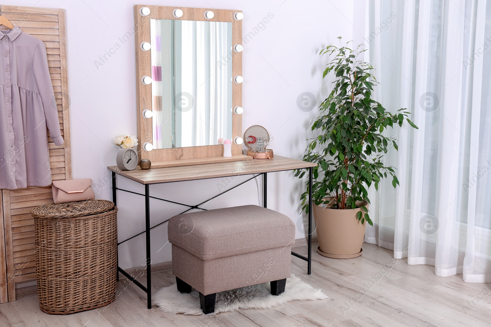 Photo of Stylish room interior with dressing table and potted ficus