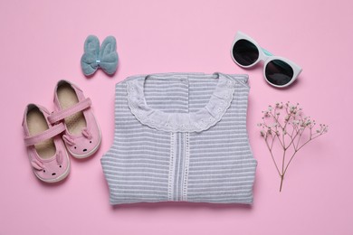 Photo of Flat lay composition with stylish child clothes and accessories on pink background