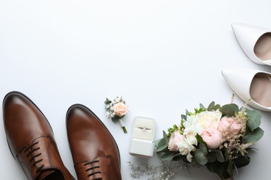 Composition with wedding shoes on white background, top view