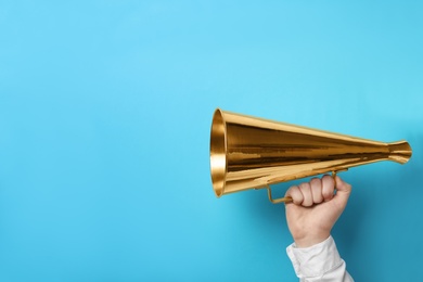 Photo of Man holding megaphone on color background