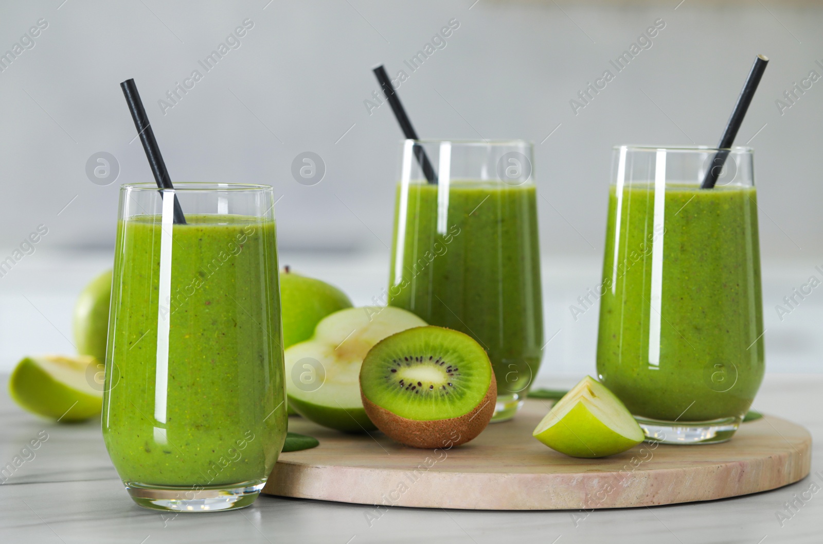 Photo of Delicious fresh smoothie and ingredients on white marble table indoors