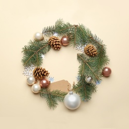 Photo of Frame made of Christmas decorations on beige background, top view with space for text. Winter season