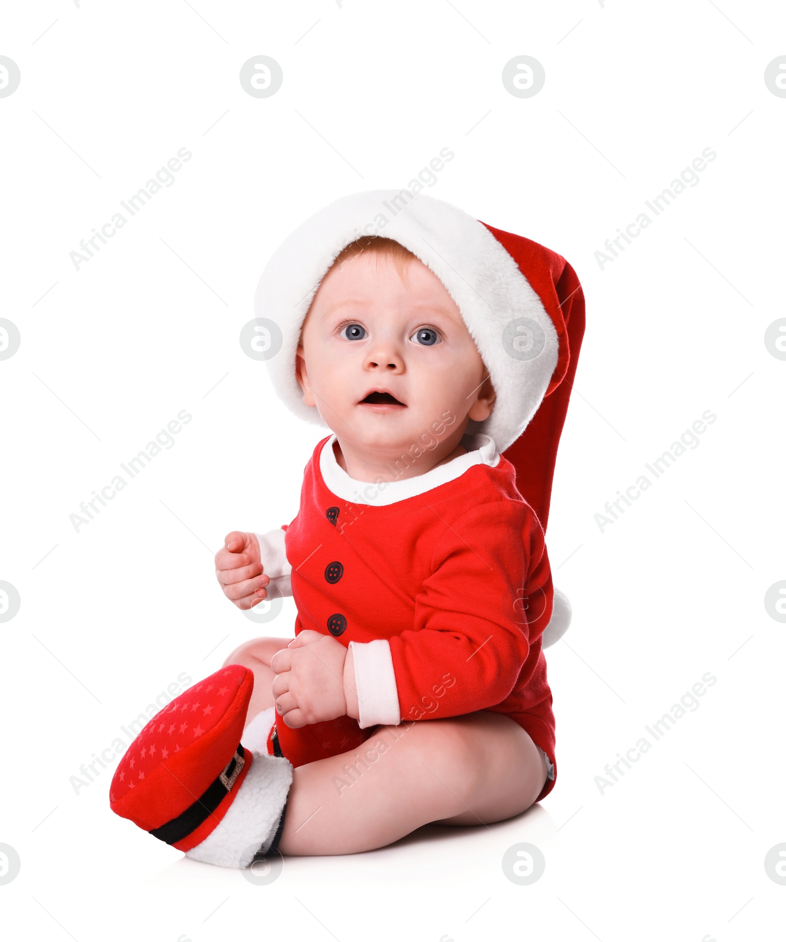 Photo of Cute little baby in Santa Claus suit on white background. Christmas celebration