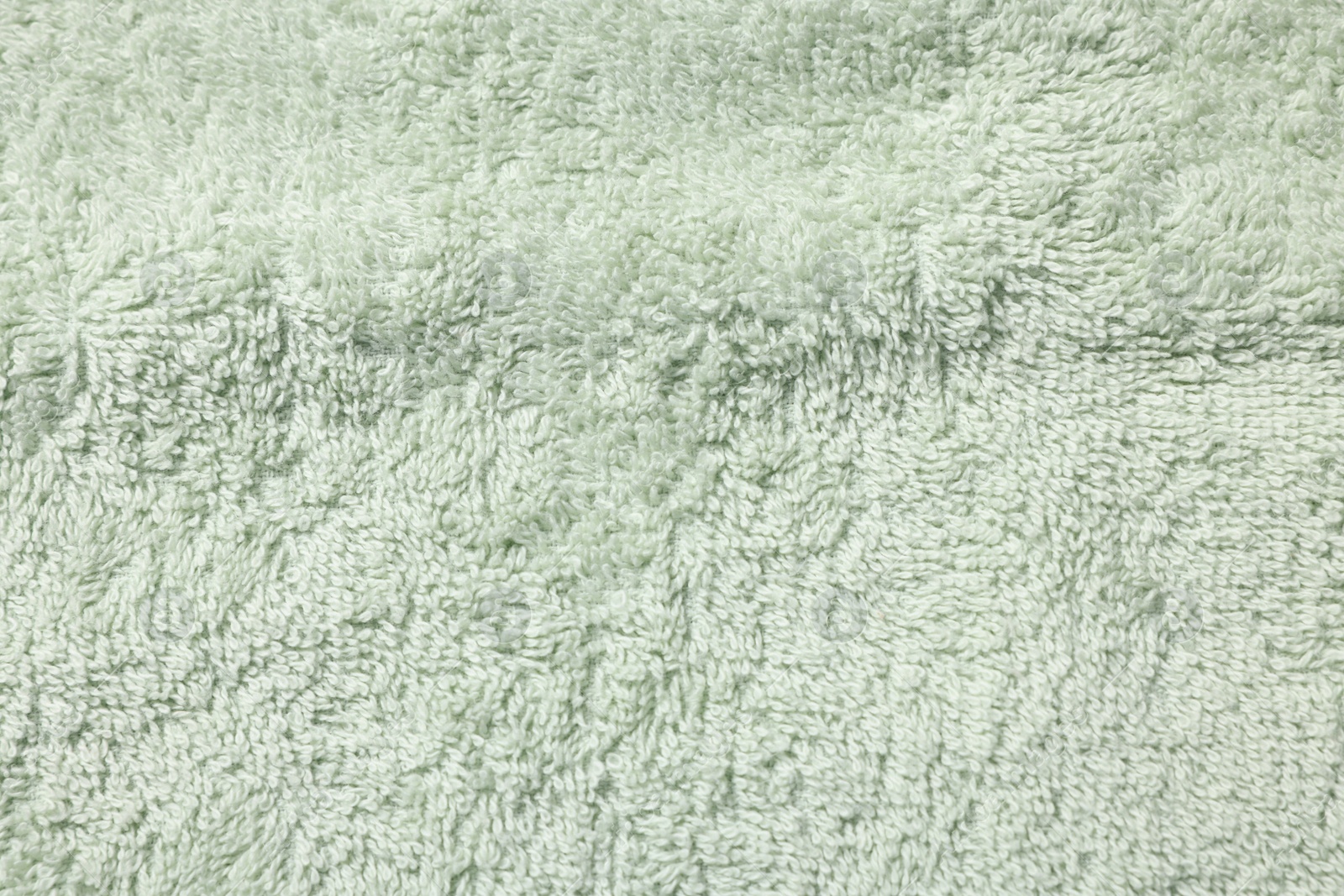 Photo of Texture of soft light green fabric as background, top view