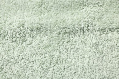 Texture of soft light green fabric as background, top view