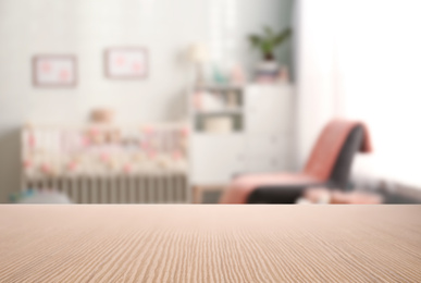 Image of Empty wooden table in baby room interior