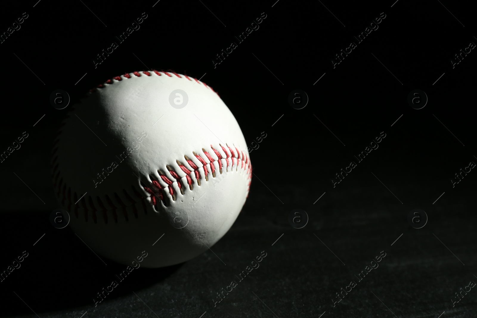 Photo of Baseball ball on black background, space for text. Sports game