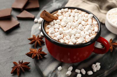 Tasty hot chocolate with marshmallows on dark textured table, closeup