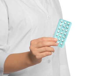 Photo of Doctor holding blister of oral contraception pills on white background, closeup