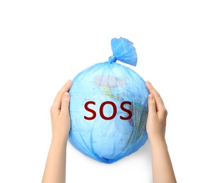 Woman holding globe with word SOS in plastic bag on white background, closeup. Environmental protection concept
