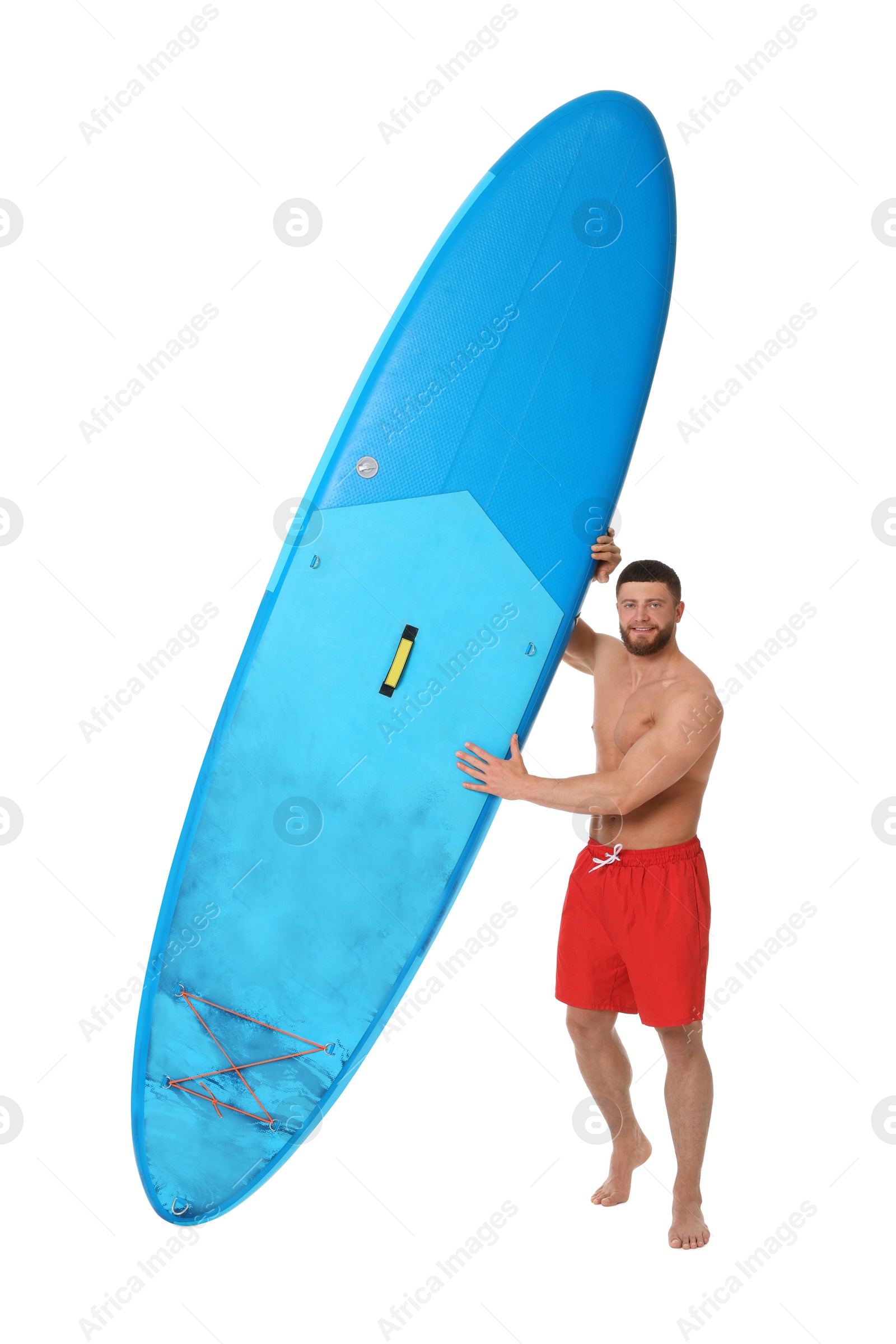 Photo of Handsome man with blue SUP board on white background