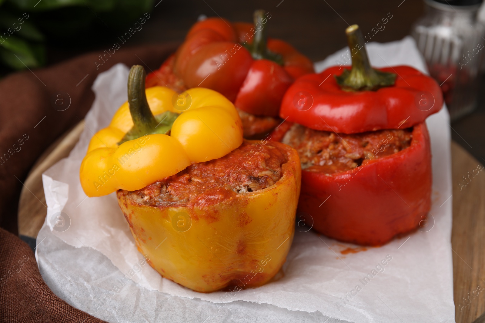 Photo of Delicious stuffed bell peppers served on wooden table, closeup