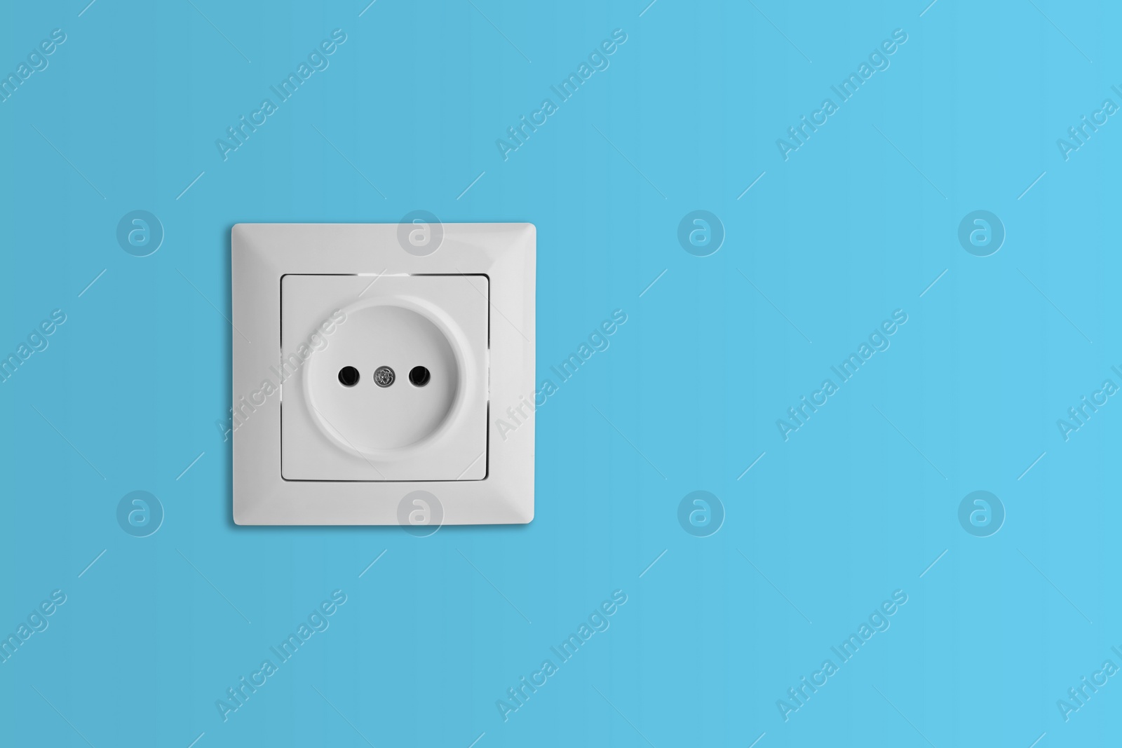 Light blue wall with power socket, space for text. Electrical supply Image of Light blue wall with power socket, space for text. Electrical supply