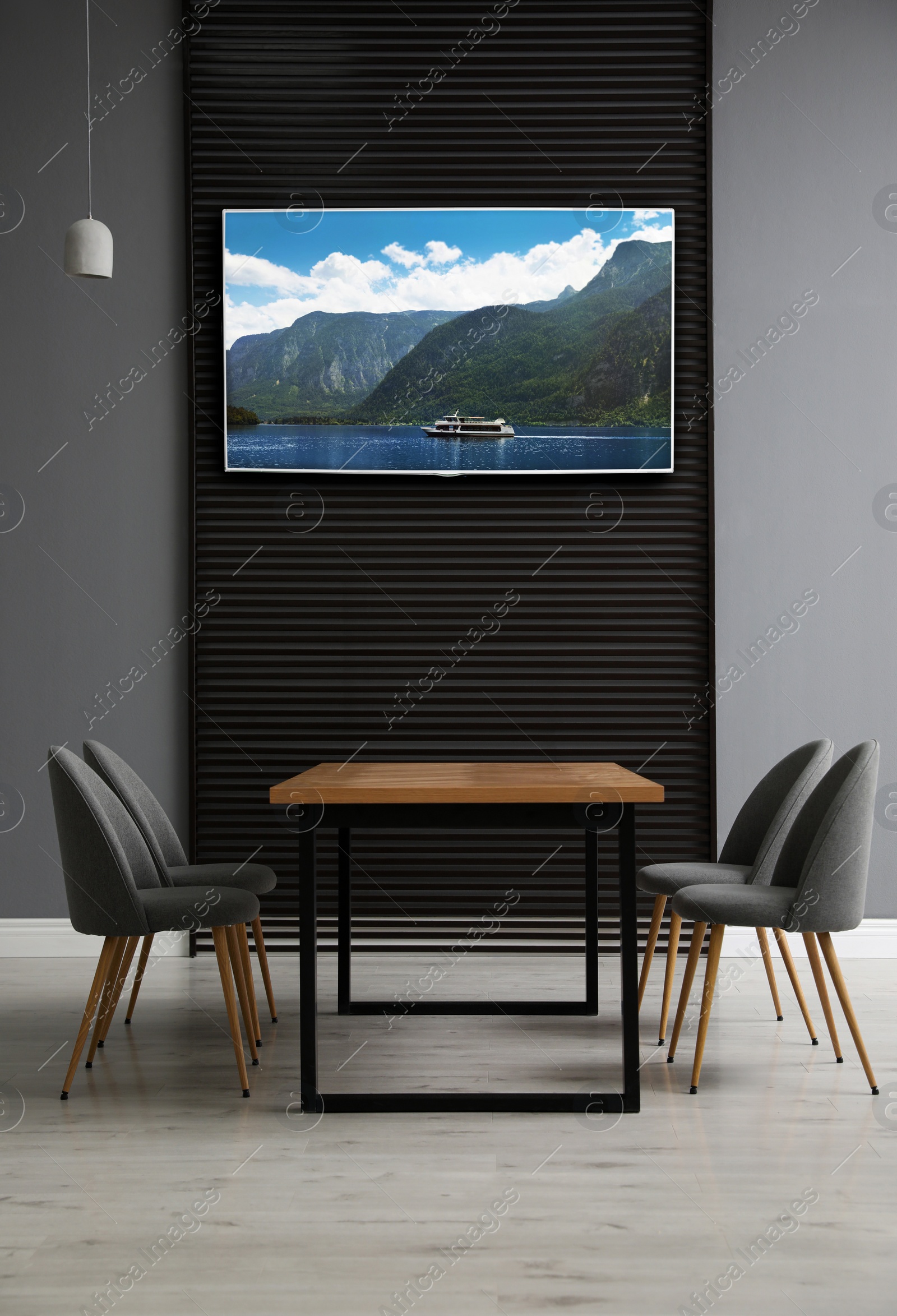 Image of Modern wide screen TV on wall in room with stylish furniture 