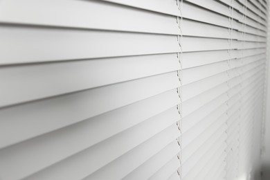 Photo of Closeup view of horizontal blinds on window indoors