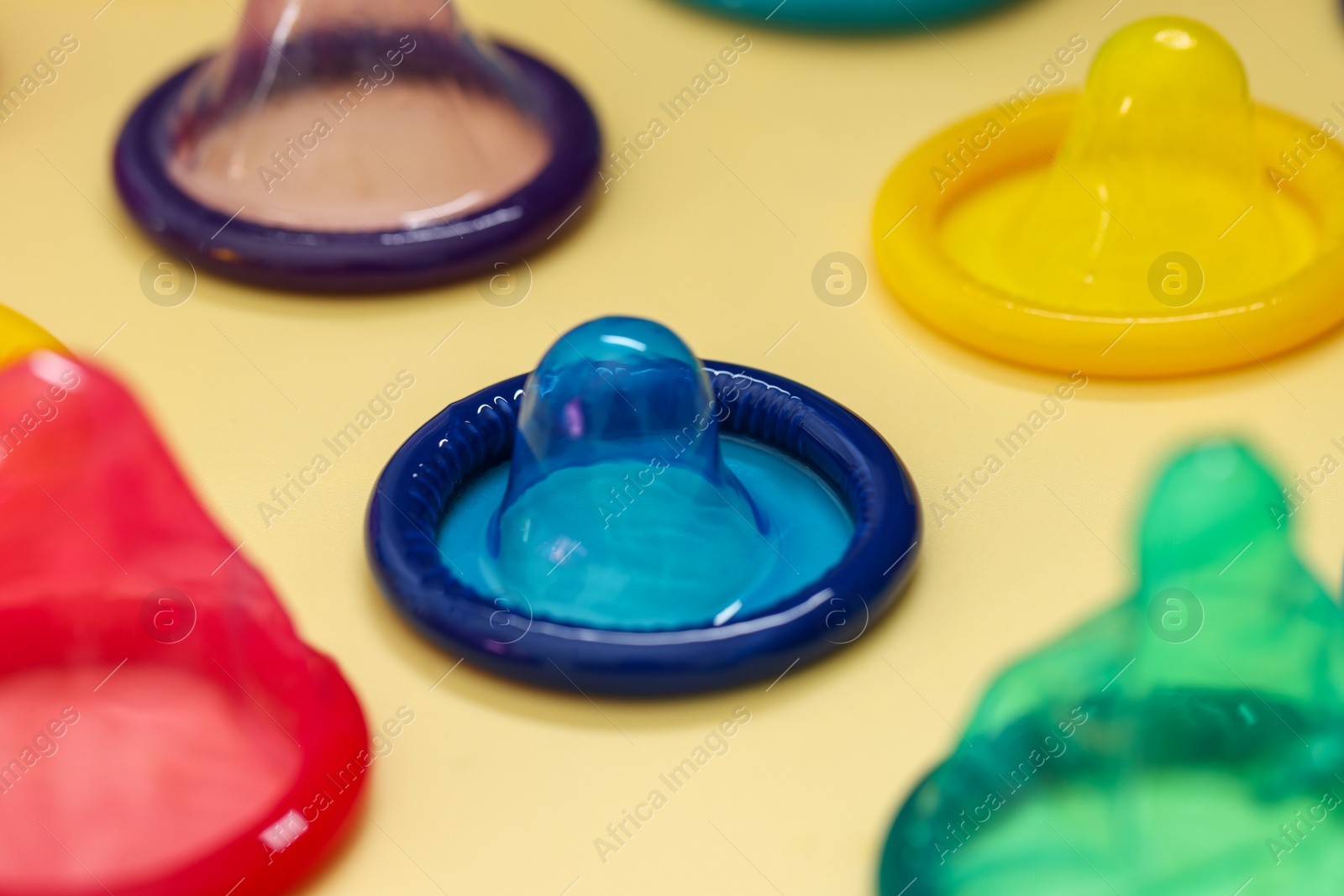 Photo of Condoms on beige background, closeup. Safe sex