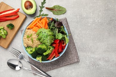 Photo of Delicious vegan bowl with bell peppers, avocados and broccoli on grey table, flat lay. Space for text